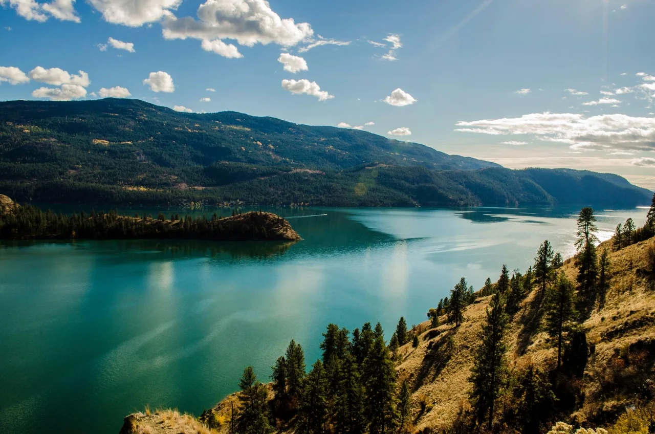 Okanagan Lake shoreline under a summer sky